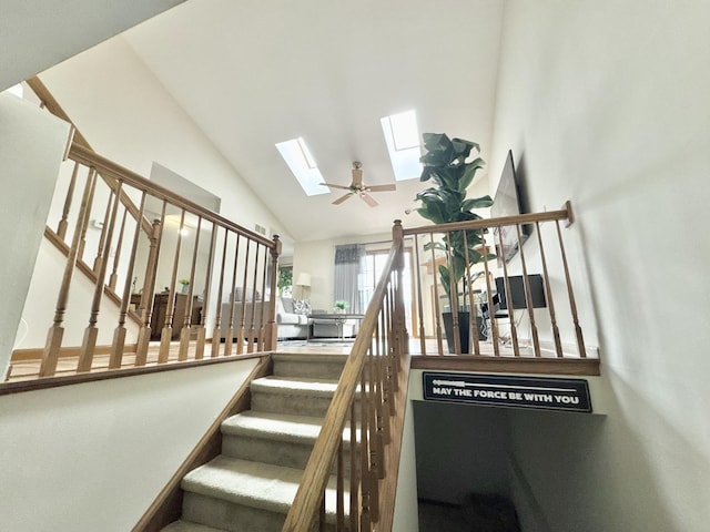 stairway with vaulted ceiling with skylight