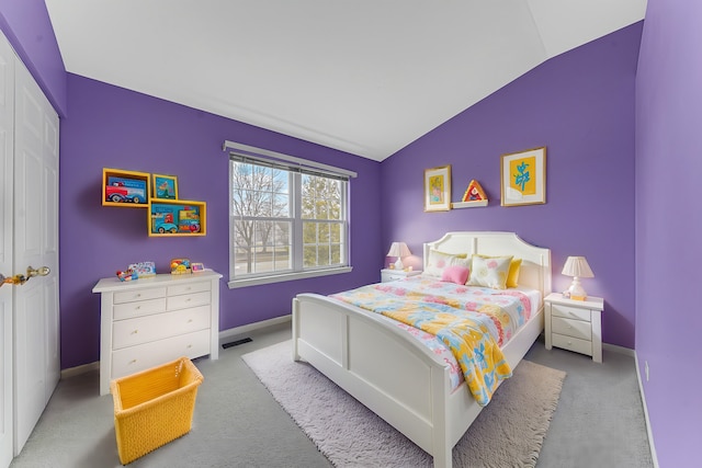 bedroom featuring lofted ceiling and light colored carpet