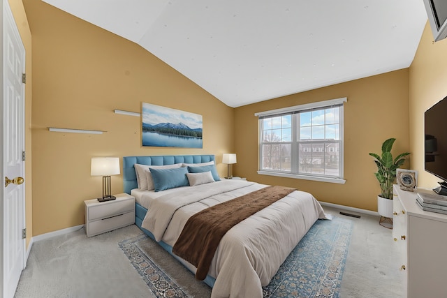 bedroom featuring vaulted ceiling and light colored carpet