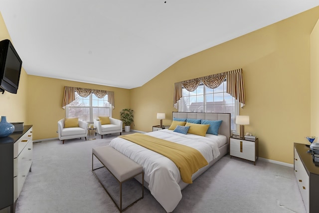 carpeted bedroom with lofted ceiling