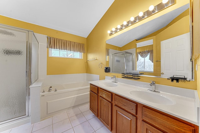 bathroom featuring tile patterned floors, separate shower and tub, vaulted ceiling, and vanity