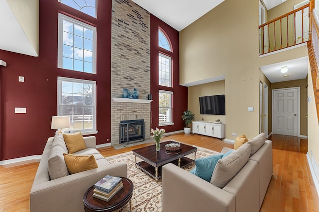 living room featuring a fireplace and light wood-type flooring