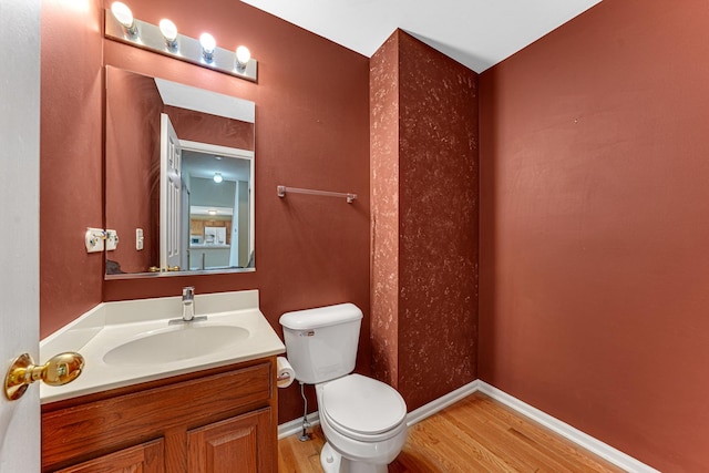 bathroom with vanity, hardwood / wood-style floors, and toilet