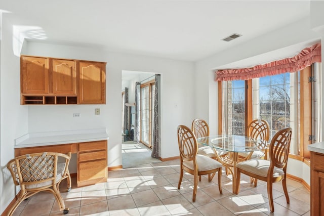 dining area with light tile patterned floors