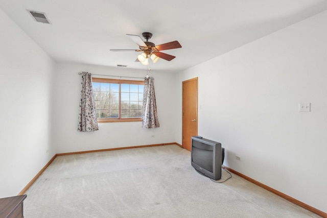 spare room with light carpet and ceiling fan