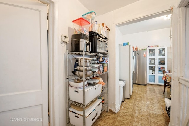 kitchen featuring stainless steel refrigerator, light parquet flooring, and white fridge