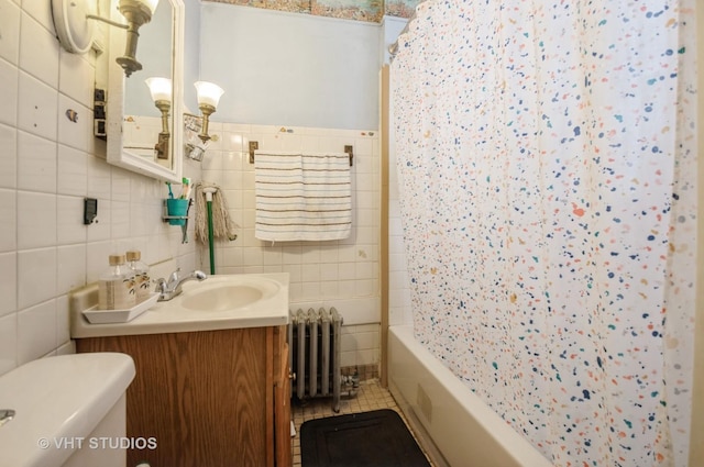 full bathroom featuring toilet, shower / tub combo, tile walls, vanity, and radiator