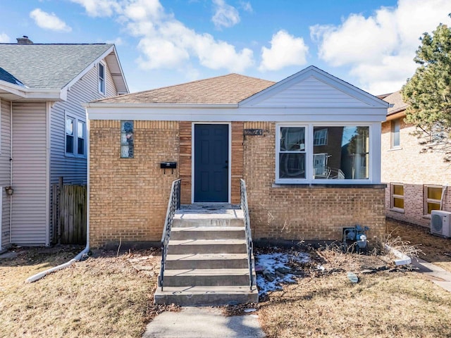 bungalow-style home with ac unit