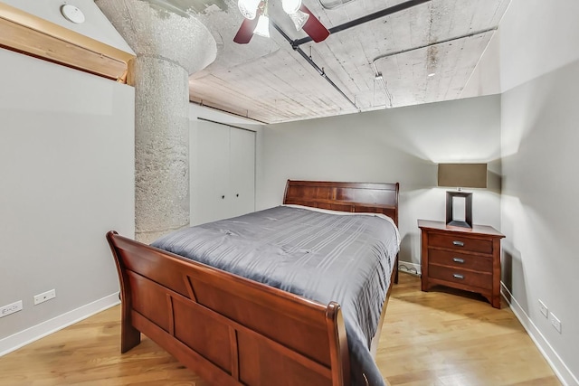 bedroom with a closet, ceiling fan, and light wood-type flooring