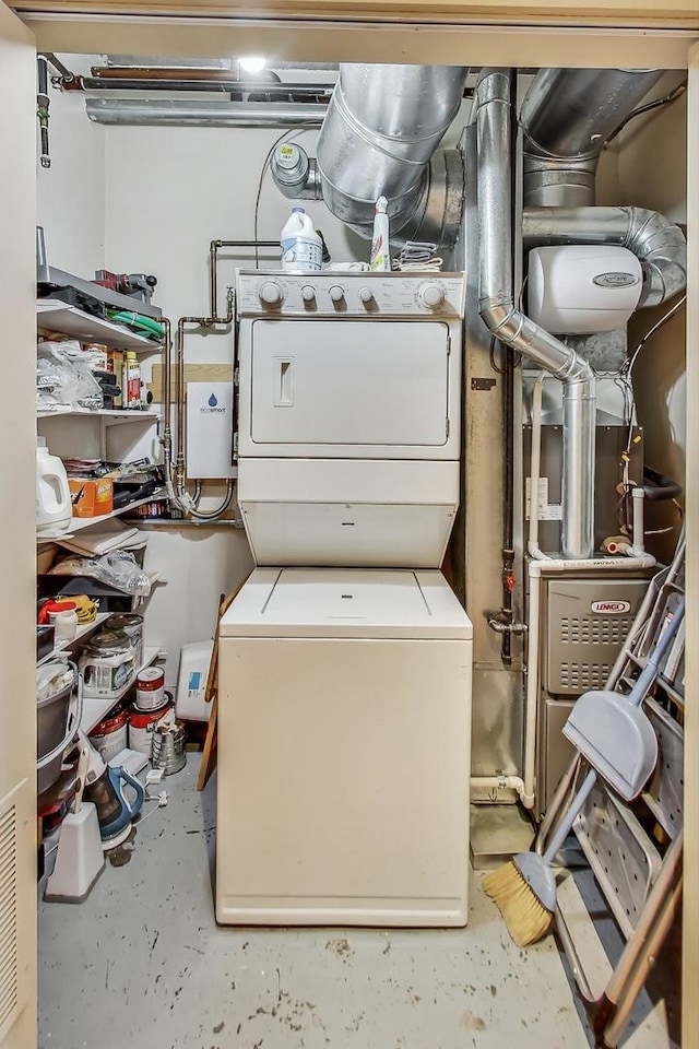 laundry room with stacked washing maching and dryer