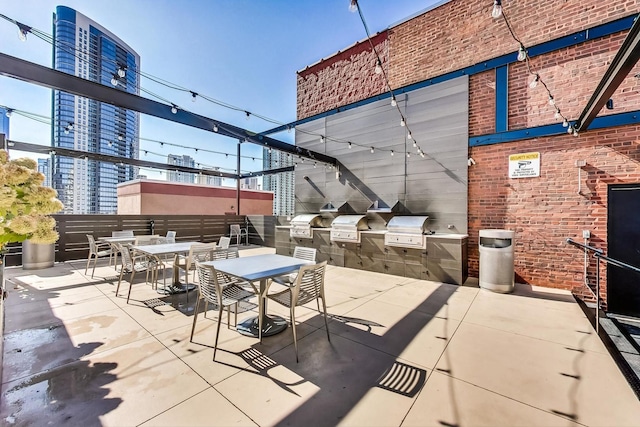 view of patio with an outdoor kitchen and a grill