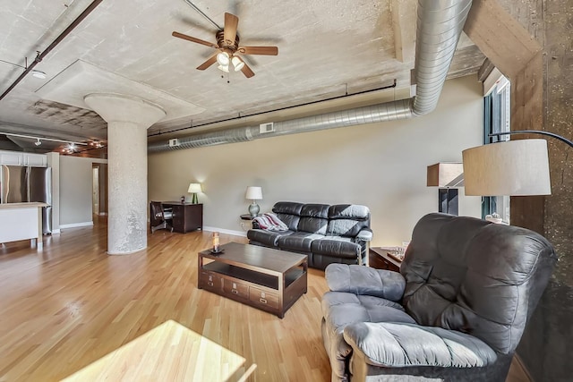 living room featuring light hardwood / wood-style floors, decorative columns, and ceiling fan