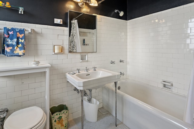 bathroom with tile walls, shower / tub combo, tile patterned floors, and toilet