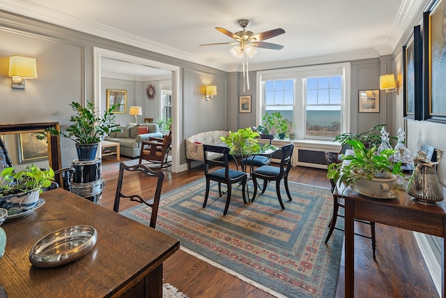 dining room featuring crown molding, dark wood-type flooring, and ceiling fan