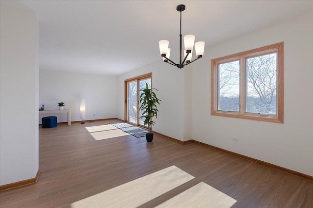 unfurnished room featuring dark hardwood / wood-style flooring and a notable chandelier