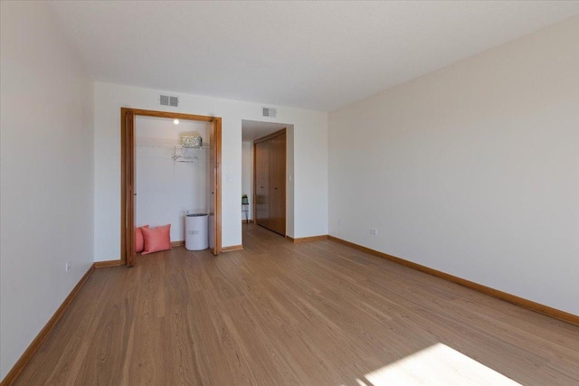 unfurnished bedroom featuring light wood-type flooring