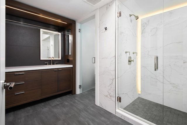 bathroom with vanity and a shower with shower door