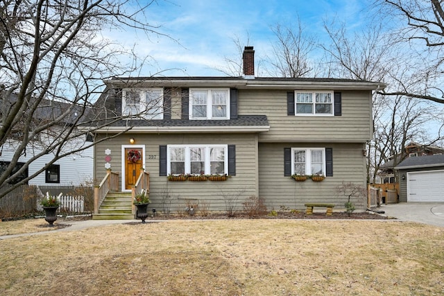 view of front property featuring a garage and a front yard