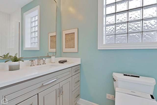 bathroom featuring vanity and toilet