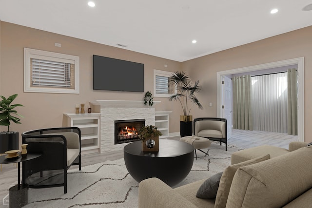 living room with a fireplace and light hardwood / wood-style floors