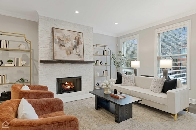 living room with crown molding, a fireplace, and light hardwood / wood-style floors