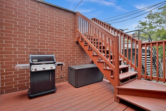 wooden terrace with a grill