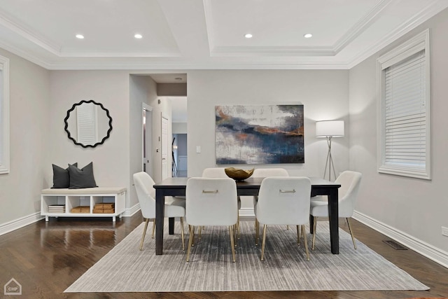 dining room with crown molding and dark hardwood / wood-style floors