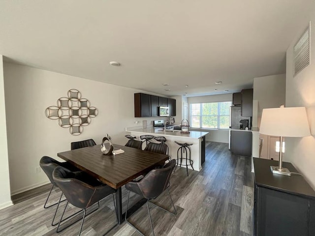 dining room with dark wood-type flooring and sink