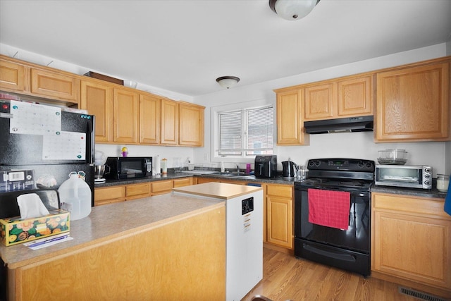 kitchen with sink, light wood-type flooring, and black appliances