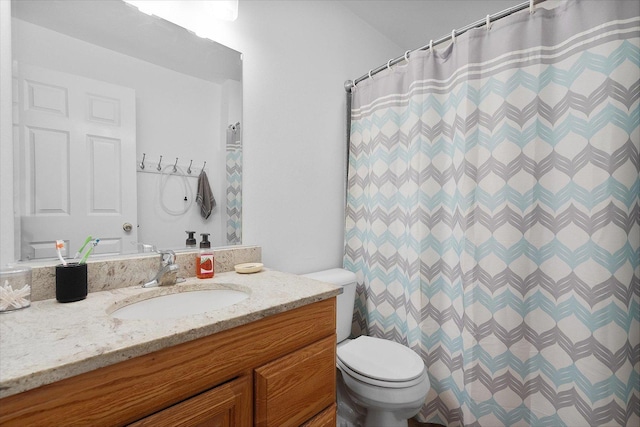 bathroom with vanity, a shower with shower curtain, and toilet