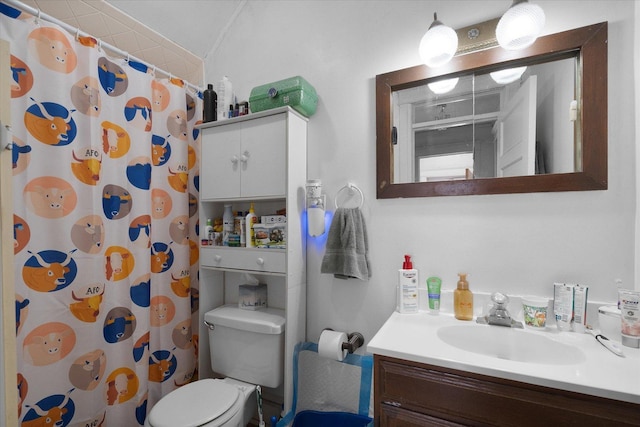 bathroom featuring walk in shower, vanity, and toilet