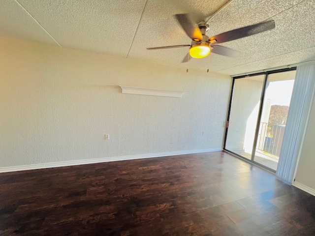 unfurnished room featuring wood-type flooring, floor to ceiling windows, ceiling fan, and a textured ceiling