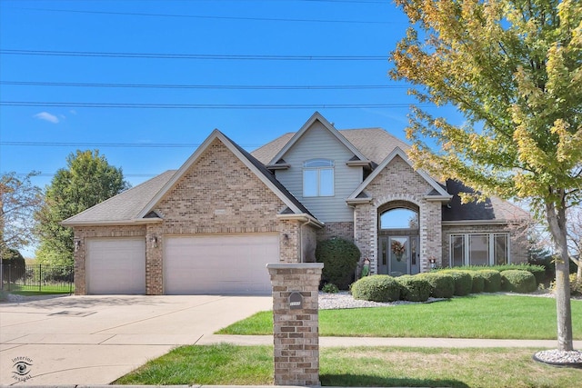 view of front facade featuring a garage and a front lawn