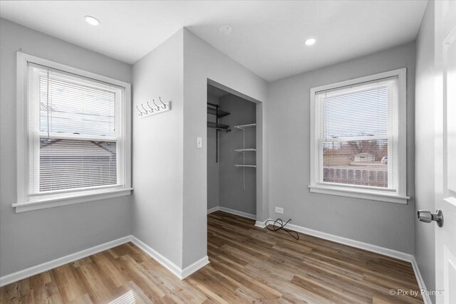 kitchen with dark brown cabinetry, light wood-style flooring, appliances with stainless steel finishes, and light countertops