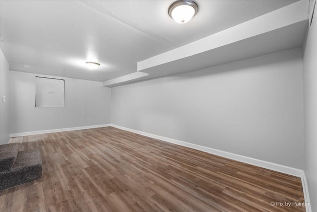 unfurnished room featuring baseboards and wood finished floors