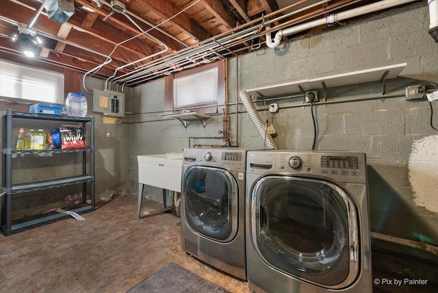 laundry room featuring laundry area, electric panel, washer and clothes dryer, and a sink