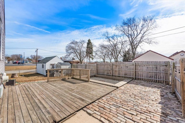 deck with an outbuilding and a fenced backyard