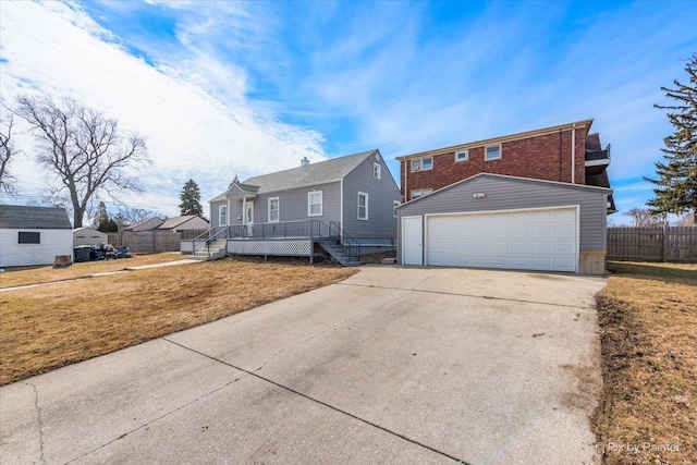 view of front of property featuring an outbuilding, fence, a deck, and a front yard