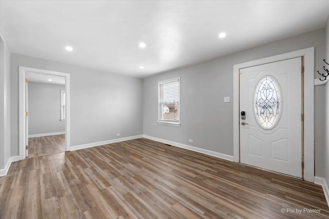 foyer featuring recessed lighting, wood finished floors, and baseboards