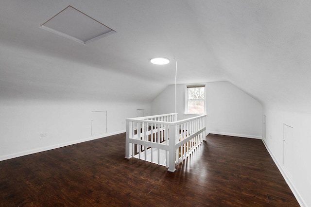 bonus room with lofted ceiling and dark hardwood / wood-style floors