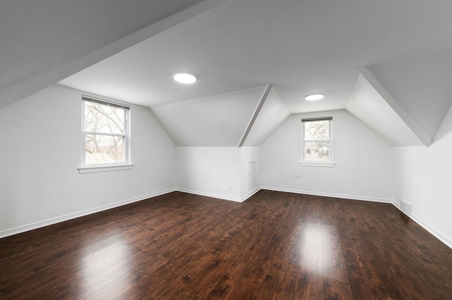 bonus room with dark hardwood / wood-style flooring and lofted ceiling