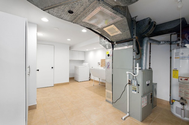 interior space with independent washer and dryer, cabinets, sink, and gas water heater