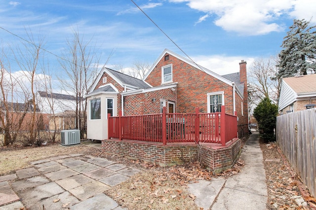 back of house featuring central AC, a deck, and a patio area