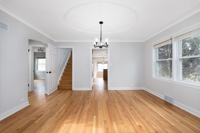 unfurnished dining area with ornamental molding, light hardwood / wood-style flooring, and a notable chandelier