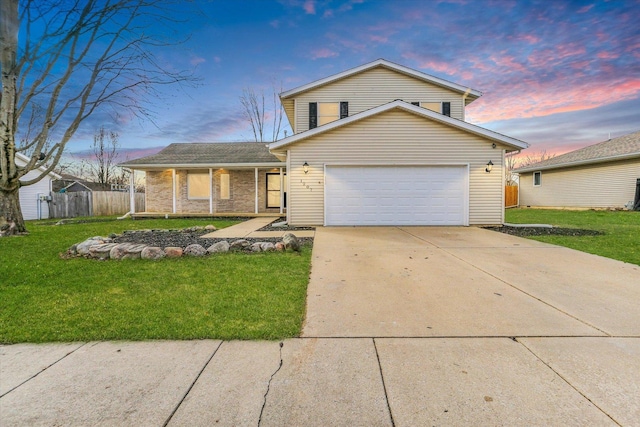 view of front of property featuring a garage, fence, concrete driveway, and a yard