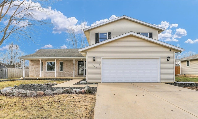 traditional-style house featuring an attached garage, covered porch, brick siding, fence, and concrete driveway