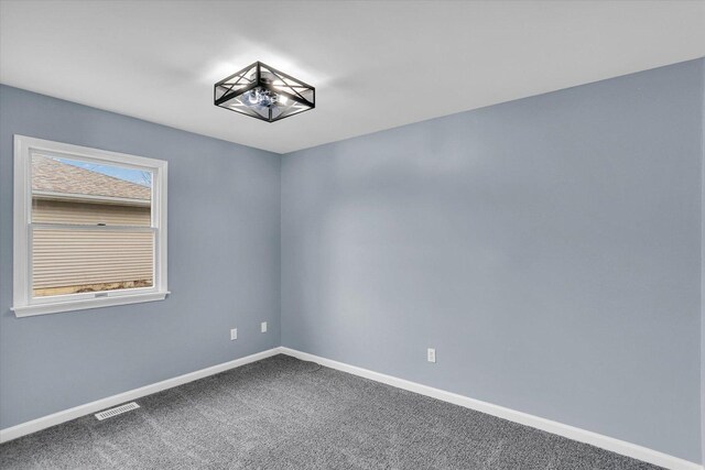 unfurnished bedroom with a closet, carpet, visible vents, and baseboards