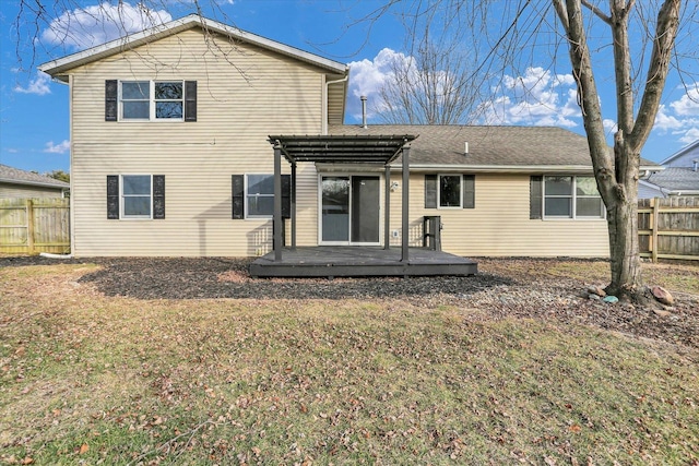 rear view of property featuring a lawn, fence, a deck, and a pergola