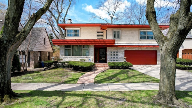 9018 S Oakley Ave, Chicago, IL 60643 - view of front of house with concrete driveway, an attached garage, a front yard, brick siding, and stone siding