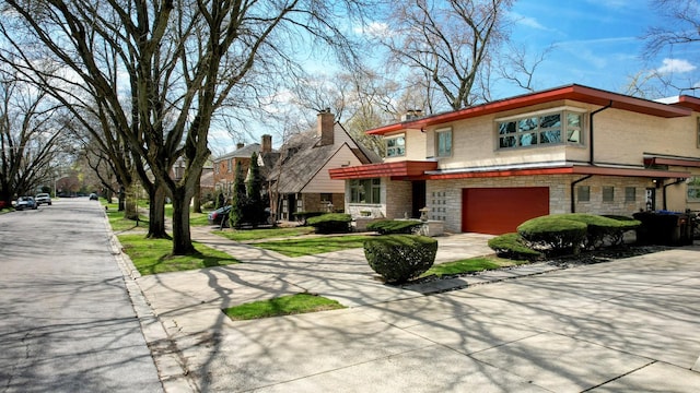 9018 S Oakley Ave, Chicago, IL 60643 - view of front facade with concrete driveway, an attached garage, stone siding, a chimney, and brick siding
